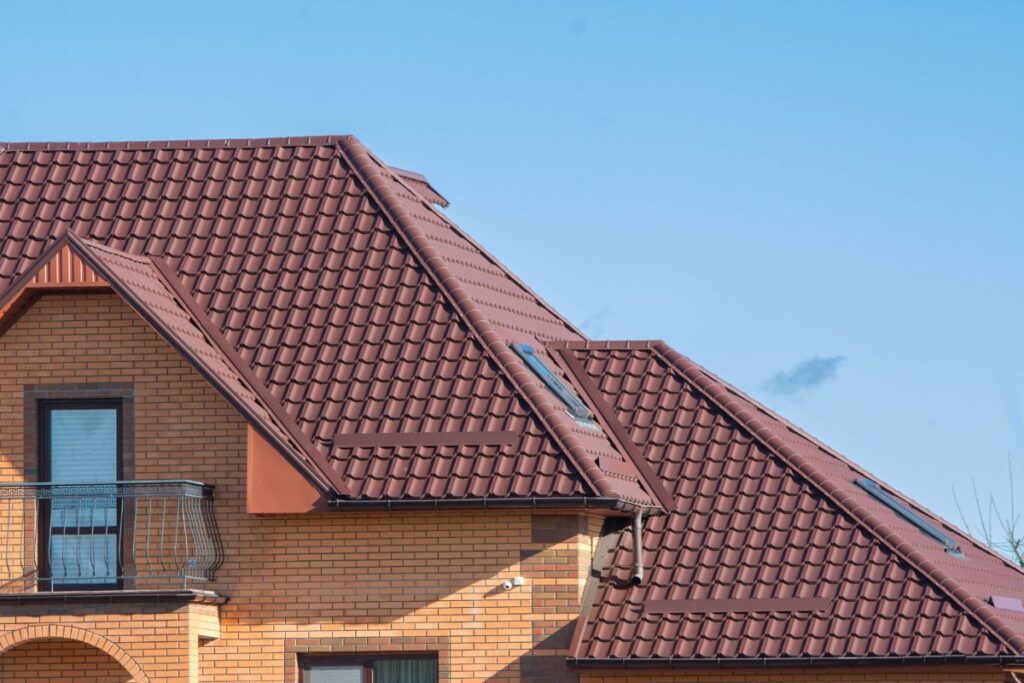 Red tile-profile metal roof on a house with a dormer